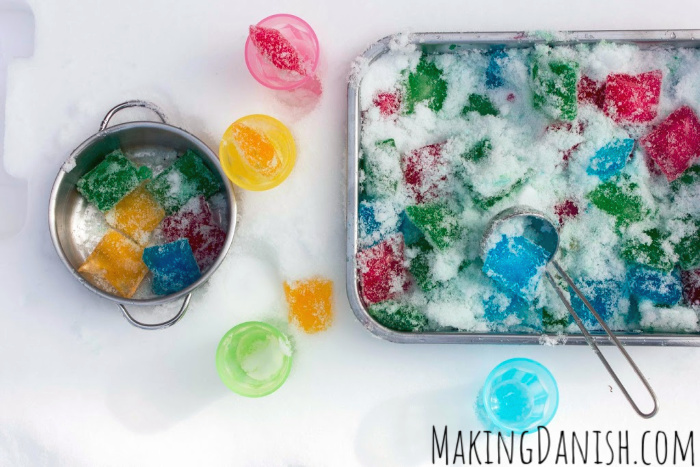 scooping coloured ice cubes in the snow