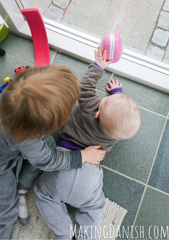 baby and sibling playing together