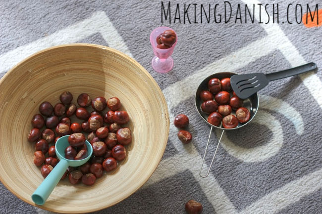 sensory bin with conkers kitchen utensils pretend play