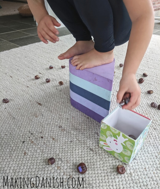 Balancing conkers play idea gross motor skills